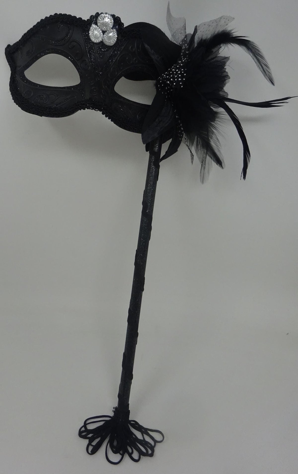 Stunning Black Jewelled Masquerade Mask on a Black Stick with a Flower and Feathers