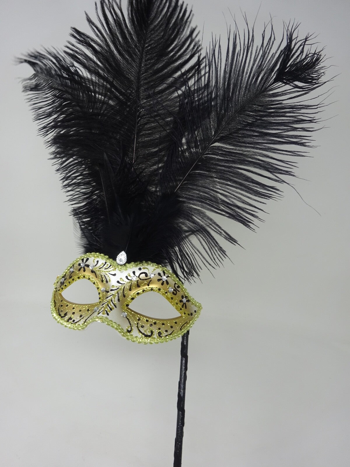 LADIES BLACK & GOLD VENETIAN MASQUERADE PARTY FEATHER MASK ON A HAND HELD STICK