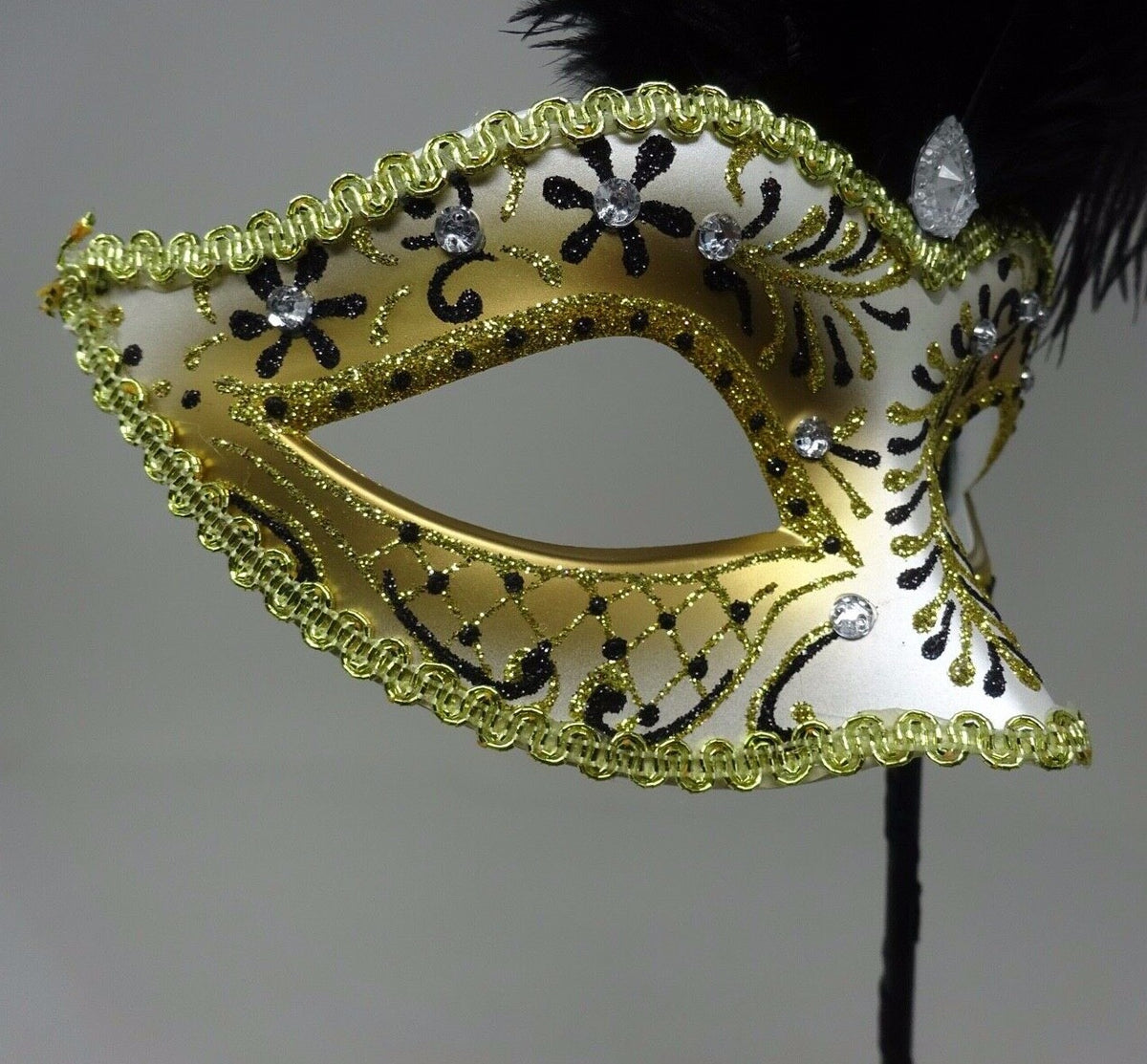 LADIES BLACK & GOLD VENETIAN MASQUERADE PARTY FEATHER MASK ON A HAND HELD STICK