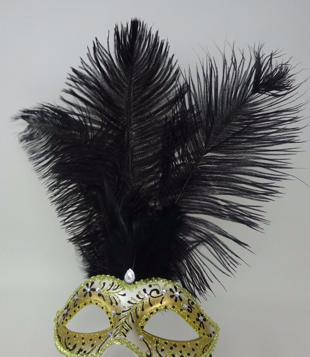 LADIES BLACK & GOLD VENETIAN MASQUERADE PARTY FEATHER MASK ON A HAND HELD STICK