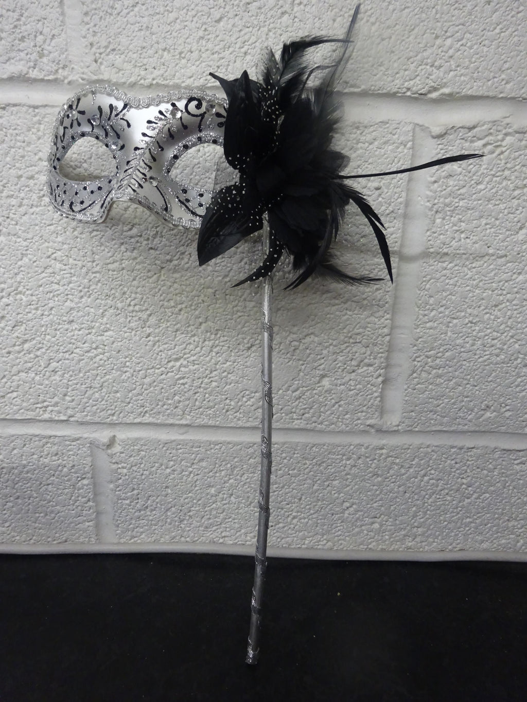 Stunning Black and Silver Feather Masquerade Mask with a Flower & Feathers on a Silver Stick