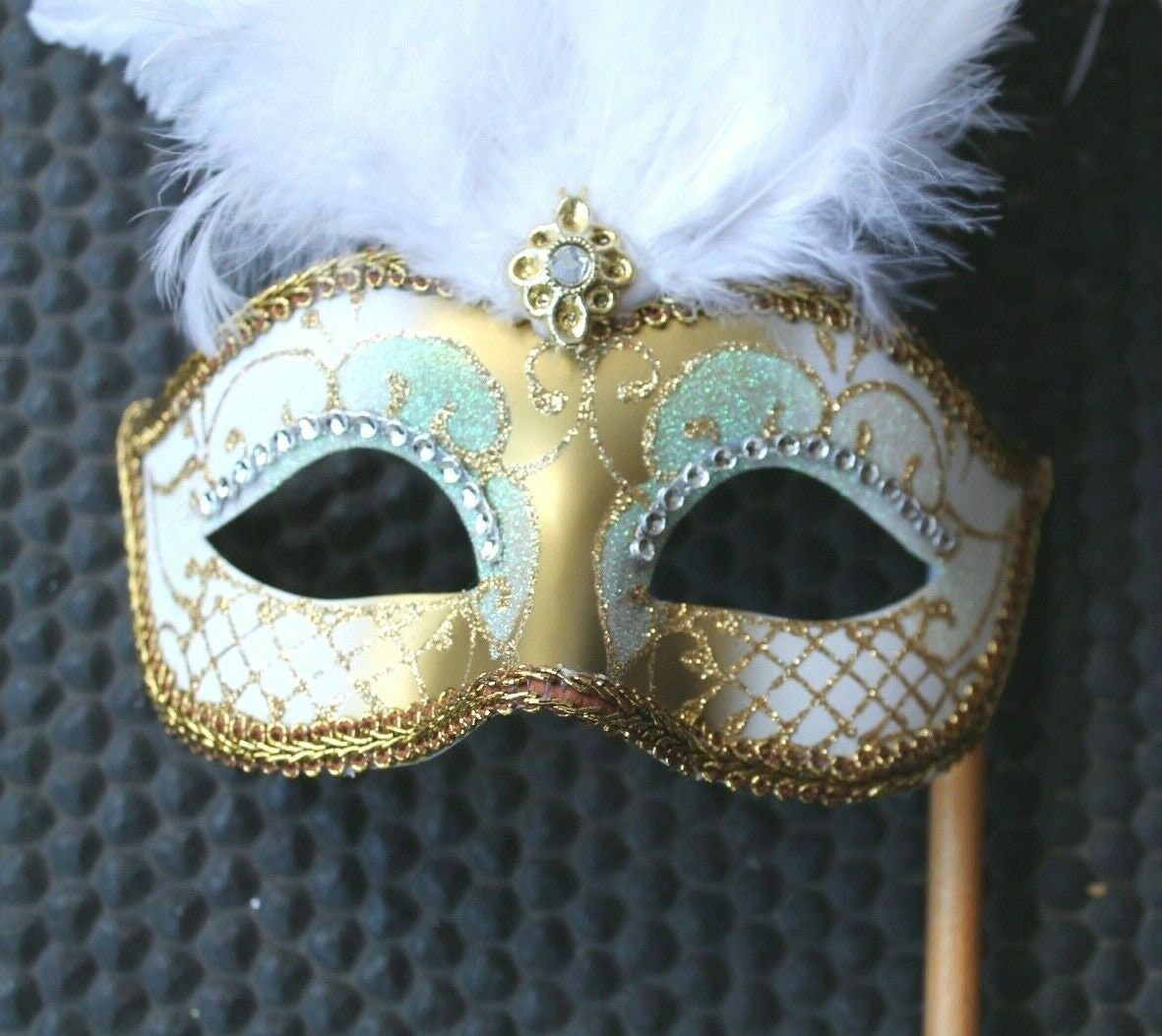 White and Gold Feather Masquerade Mask on a Gold Stick with Diamontes