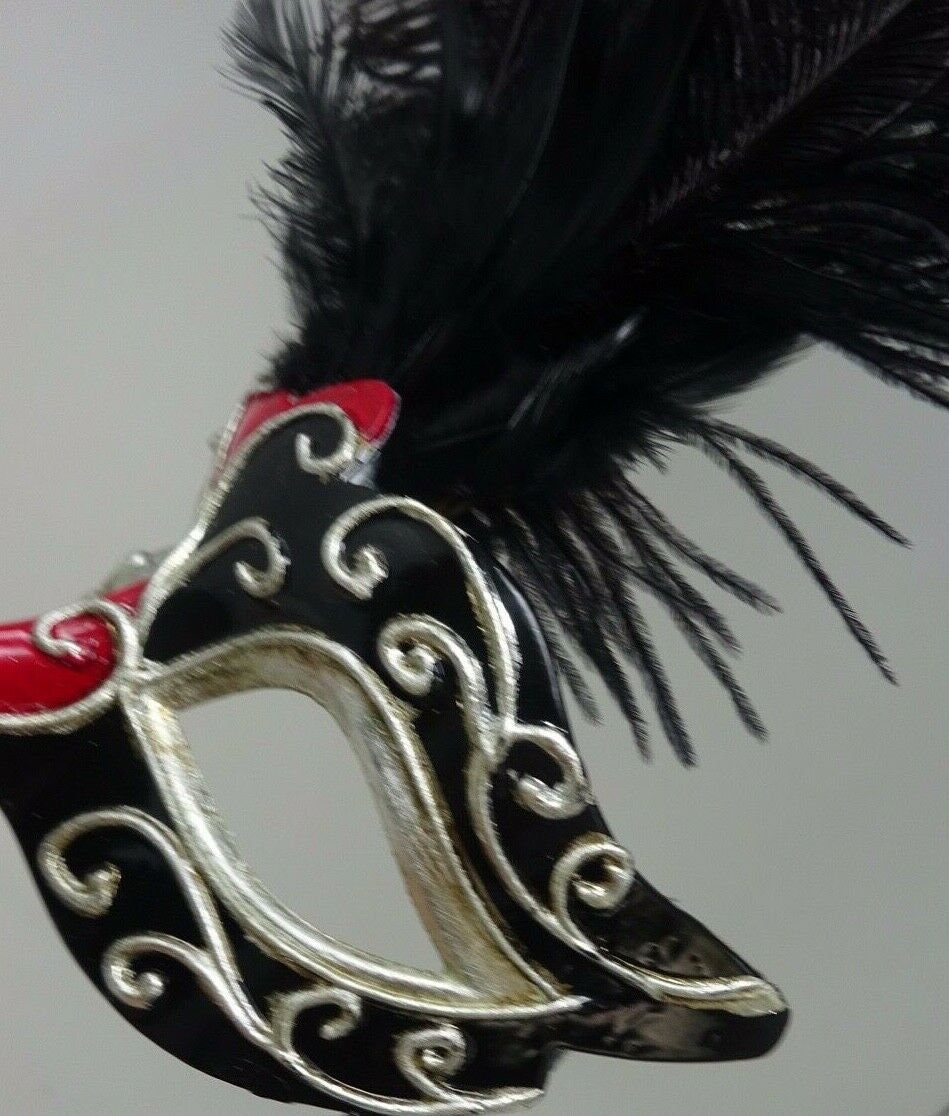 Ladies Red, Black and Silver Musical Masquerade Mask for Masked Ball with Layered Long Black Feathers Hand Held on a Wooden Stick
