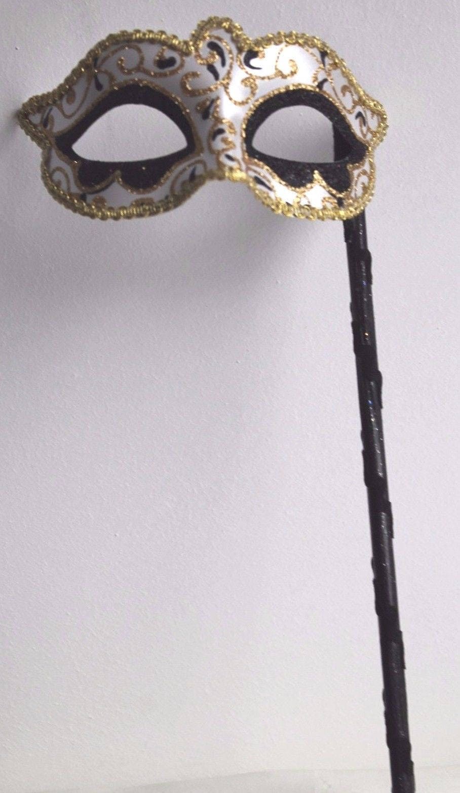 Glittering Black and Gold Masquerade Mask on a Gold Stick