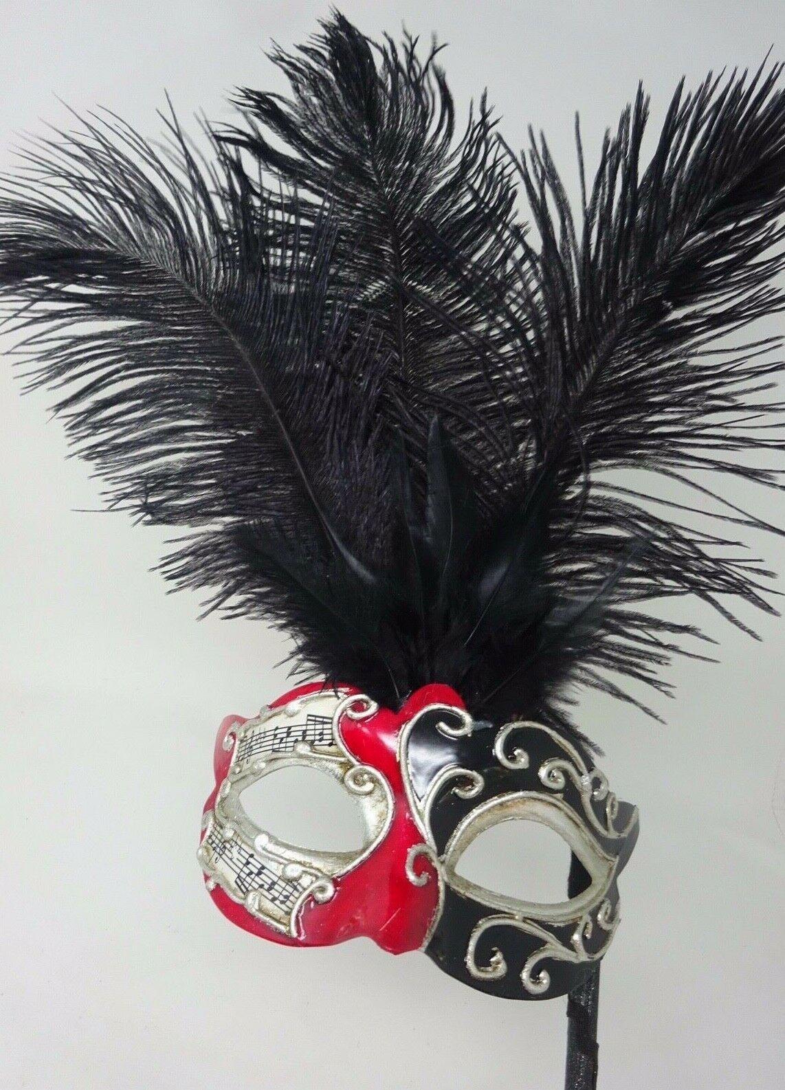 Ladies Red, Black and Silver Musical Masquerade Mask for Masked Ball with Layered Long Black Feathers Hand Held on a Wooden Stick