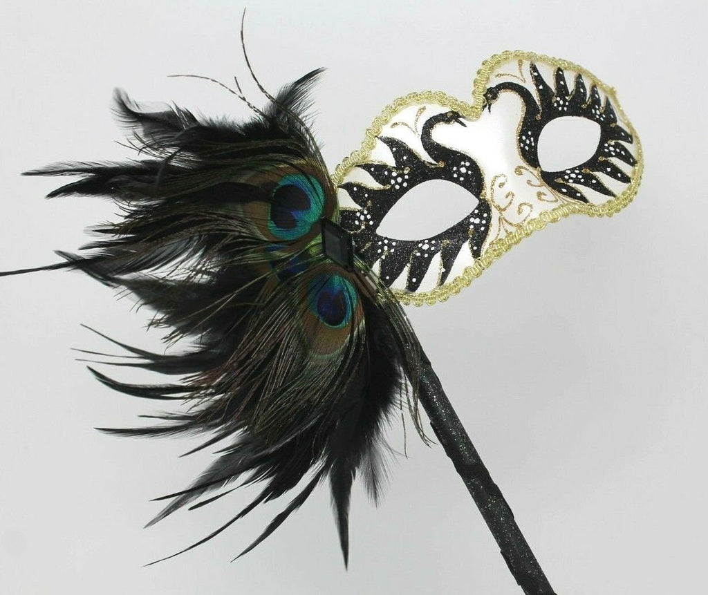 Gold White and Black Masquerade Mask on a Black Stick with Peacock Feathers
