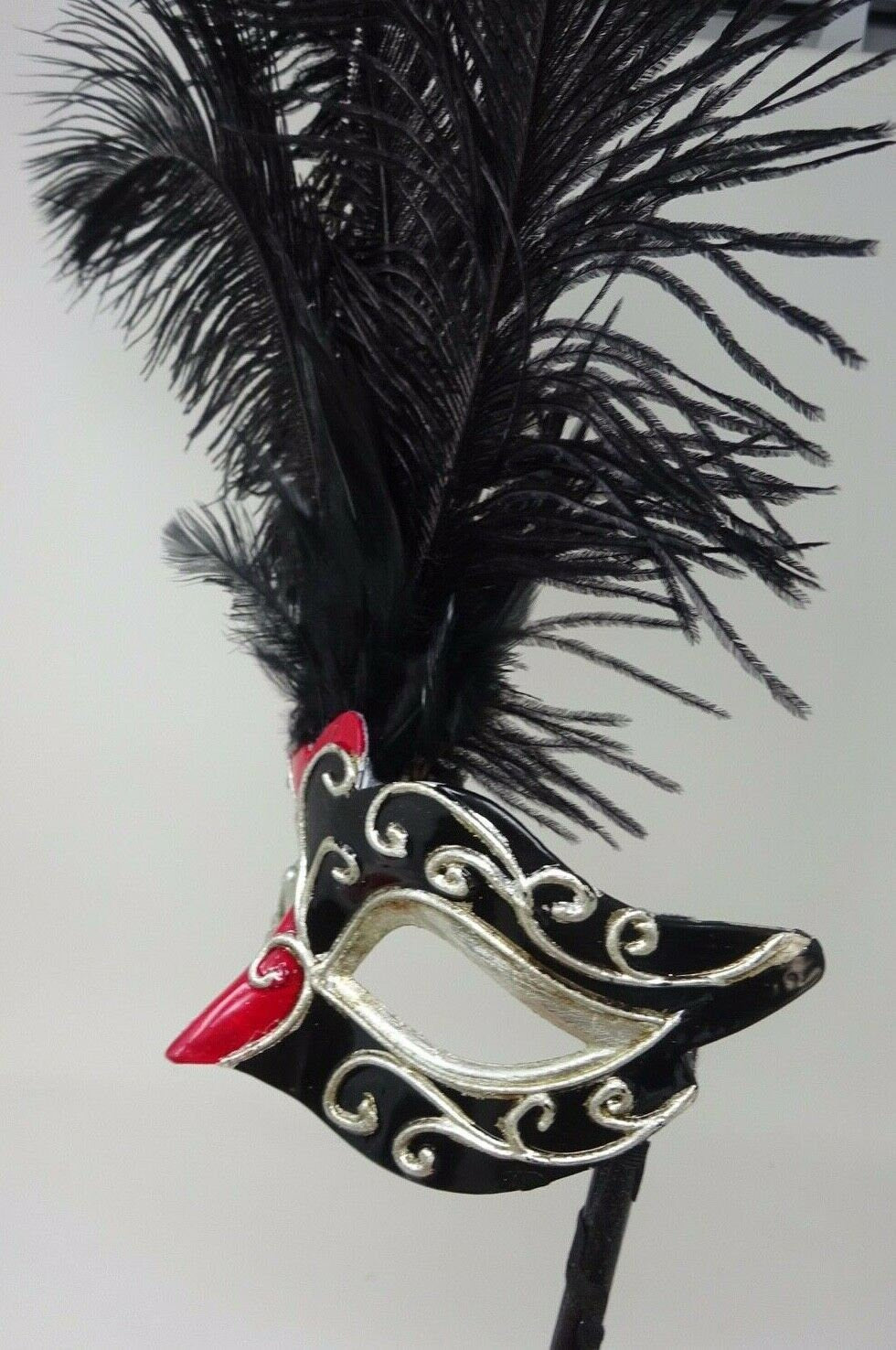 Ladies Red, Black and Silver Musical Masquerade Mask for Masked Ball with Layered Long Black Feathers Hand Held on a Wooden Stick